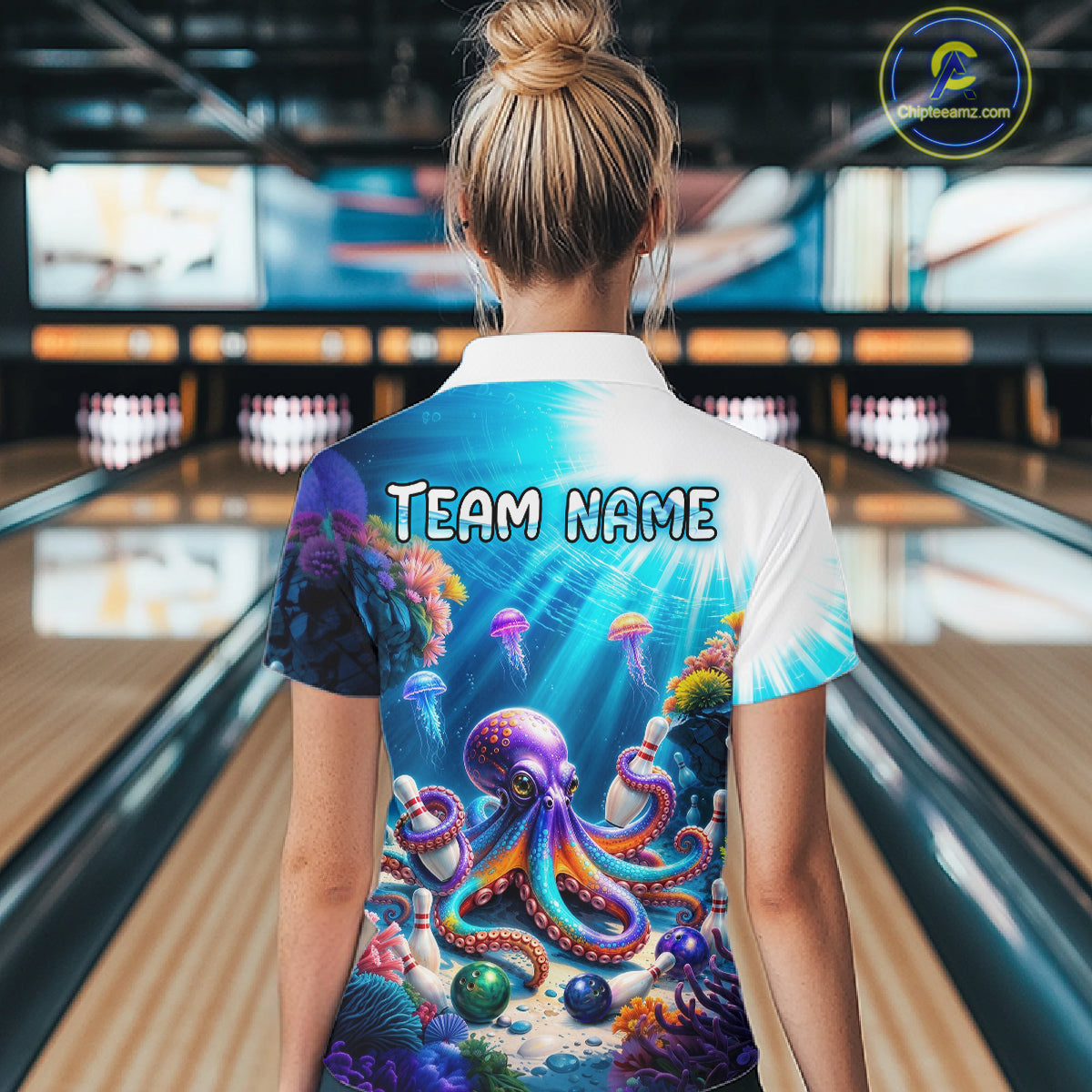Woman wearing a colorful shirt with an octopus design in a bowling alley.