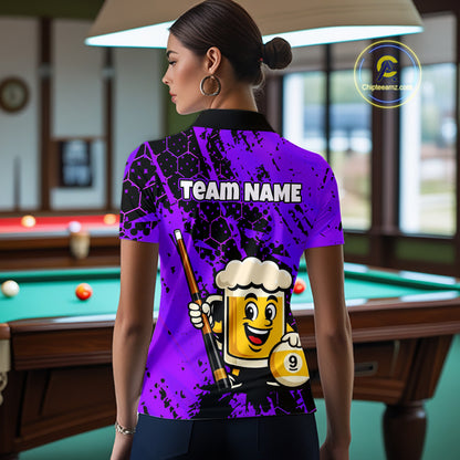 Woman wearing a bright purple billiards polo with black splatter graphics, custom “TEAM NAME” text, and a smiling beer mug mascot holding a pool cue.