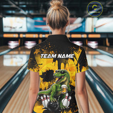 Load image into Gallery viewer, Women wearing bowling quarter zip shirt featuring a dinosaur holding beer with bowling pins and ball artwork on black yellow background.