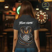 Load image into Gallery viewer, Women wearing darts polo shirt featuring a cobra wrapped around a dartboard with cobra snake artwork on a black background.