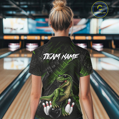 Women wearing bowling quarter zip shirt featuring a dinosaur standing among bowling pins and ball artwork on black green textured background.
