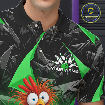 A close-up of a person wearing a black short-sleeve polo shirt with a green and gray abstract pattern, a bowling pin graphic with the text 'YOUR NAME', and a cartoon bird character at the bottom. A circular 'ChipteeAmz.