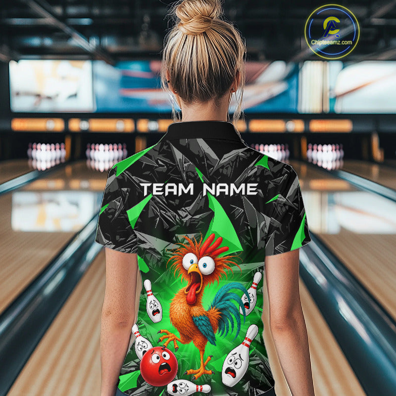 A woman viewed from behind wearing a short-sleeve bowling-themed polo shirt with a cartoon rooster, bowling pins, and bowling balls on the back, set against a bowling alley background.