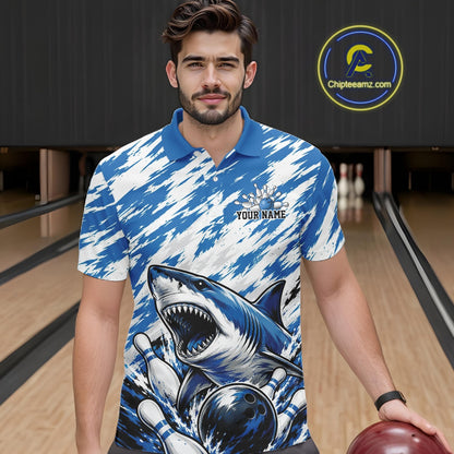 Man wearing a blue and white polo shirt with a shark design in a bowling alley.