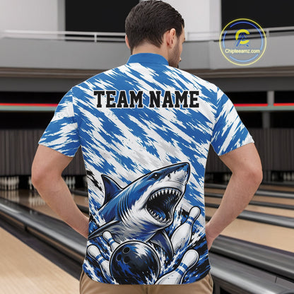 Person wearing a blue and white patterned shirt with a shark design and 'TEAM NAME' text on a bowling alley background.