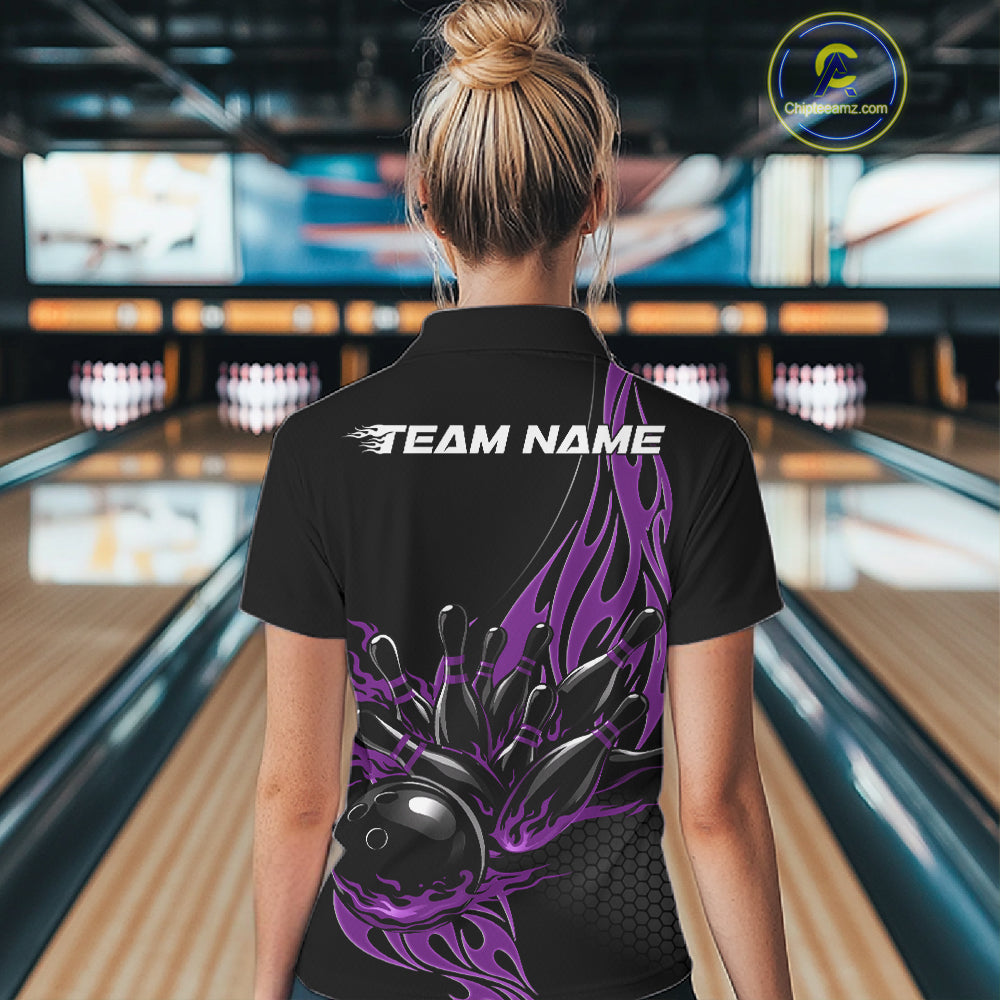 Back view female model in bowling alley wearing black quarter zip shirt featuring purple flaming bowling action graphic design