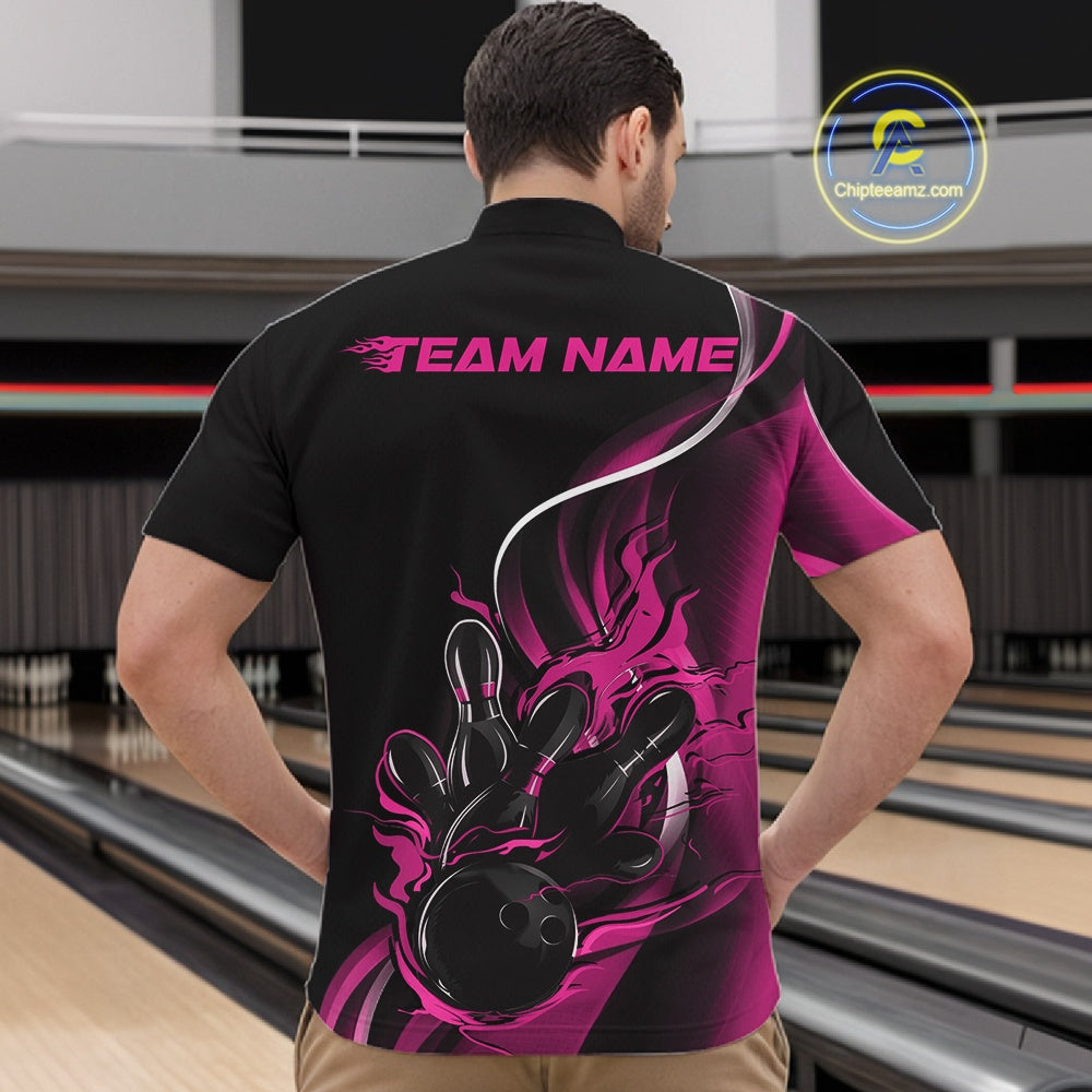 Male model front view at bowling lane wearing black and pink quarter zip shirt with flaming bowling ball hitting pins energetic artwork
