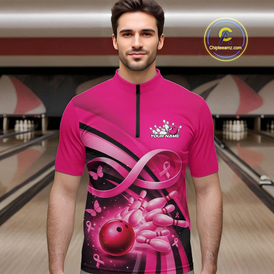 Male model in a bowling alley wearing a pink quarter zip shirt with breast cancer awareness ribbons, butterflies, and bowling graphics.