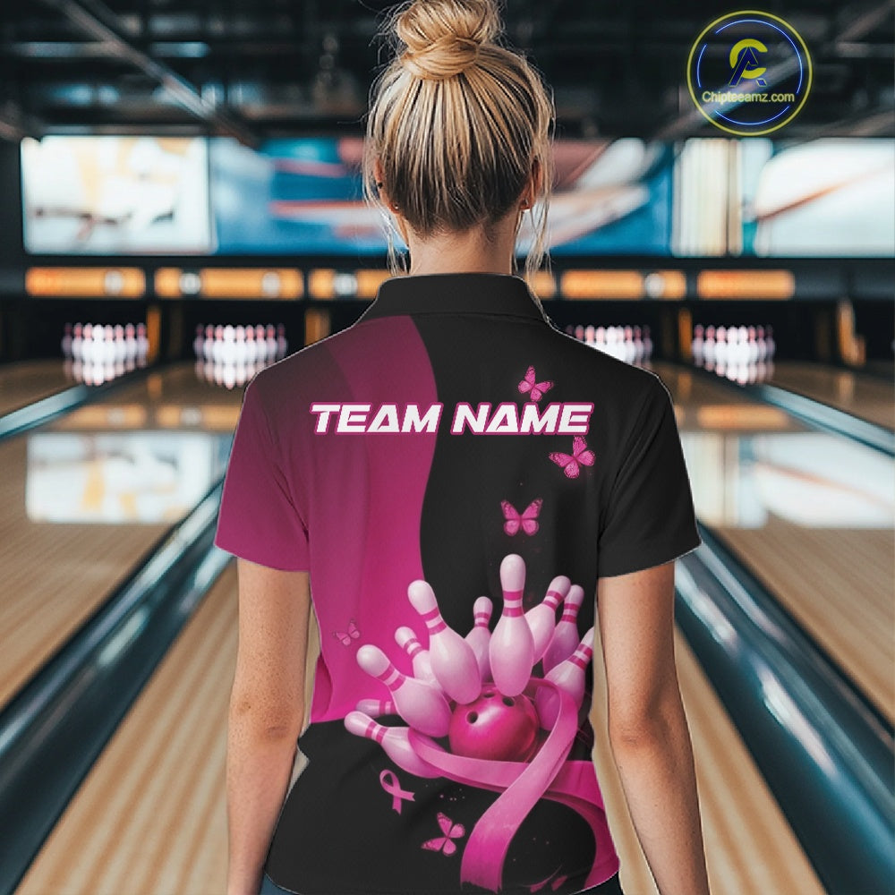 Back view of a black and pink women s bowling quarter zip with breast cancer awareness ribbons, butterfly artwork, and bowling graphics in a bowling venue.