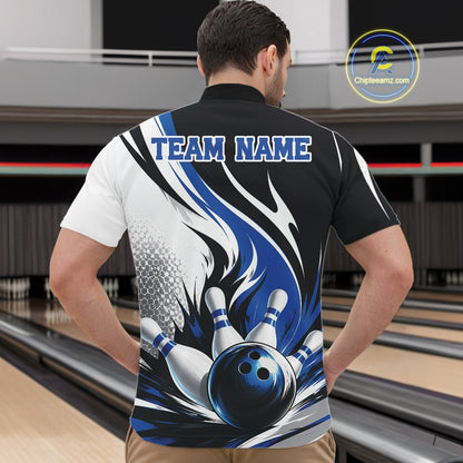 Male model wearing a white, black, and blue bowling quarter zip shirt with a flaming bowling ball knocking down pins graphic, shown from the front at a bowling lane.