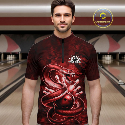 Male model at the bowling lane wearing a quarter-zip decorated with red cobra artwork and bowling-themed graphics.