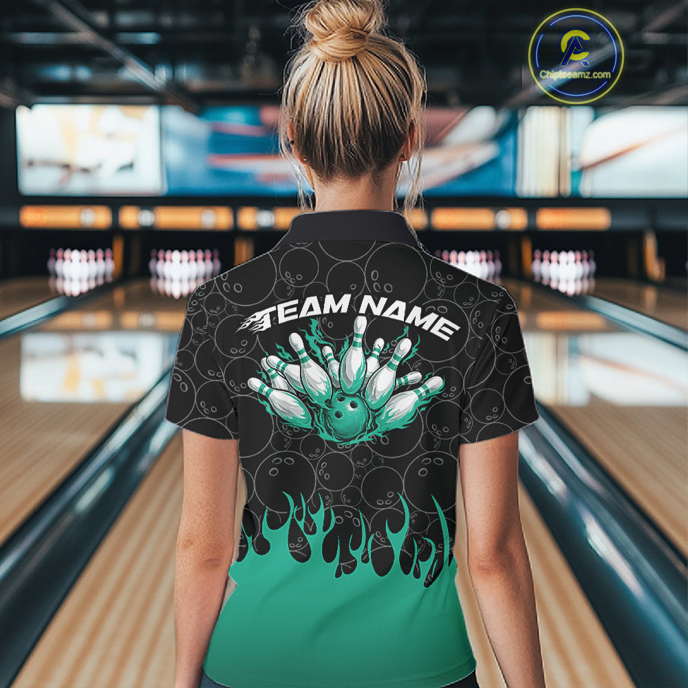 Back view of a female model in a bowling lane wearing a black polo shirt with bowling ball pattern and vibrant turquoise green flames rising in a bold sporty bowling design.