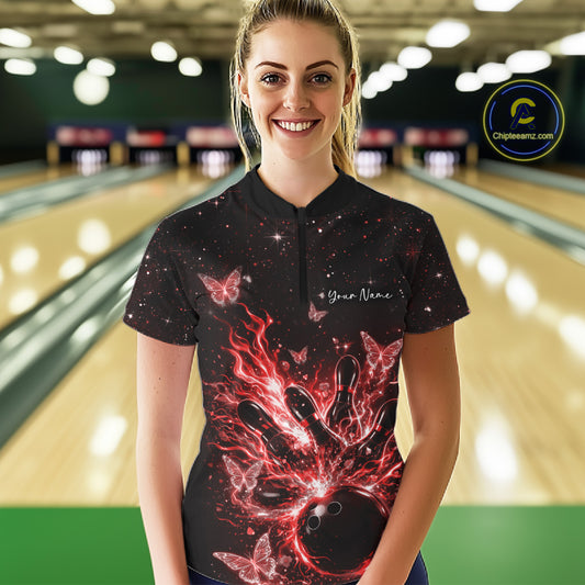 Female model in a black and red bowling quarter-zip shirt at the lane with cosmic flaming bowling artwork.