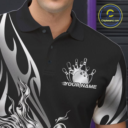 Close-up view of the left chest area of a black polo shirt showing a silver metal tribal flame bowling ball and pins design detail.