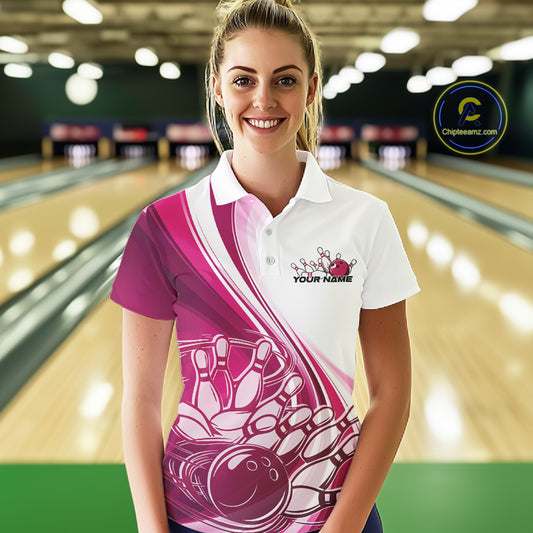 Female model in a bowling lane wearing a white and pink polo shirt with a sweeping curve bowling strike graphic and pins being knocked down.