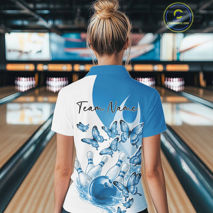 Back view of a female model wearing a white and blue bowling quarter zip with butterfly artwork and bowling graphics