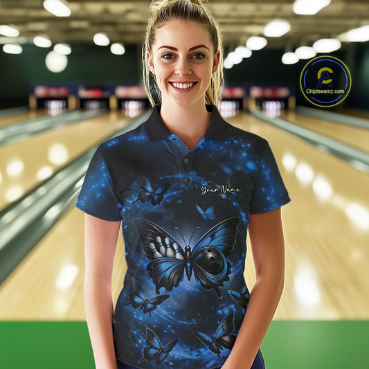 Female model at a bowling lane wearing a bowling polo shirt featuring a blue and black butterfly with a bowling ball body against a smoky background.