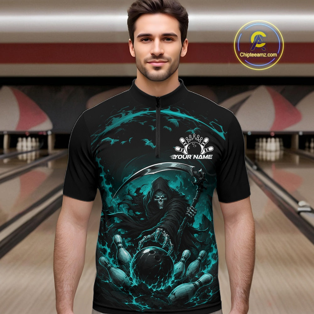 Male model shown from the front wearing a black and cyan blue bowling quarter zip shirt with a grim reaper reaching through swirling flames to command a blazing bowling ball striking scattered pins in a bowling lane.