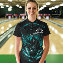 Load image into Gallery viewer, Front view of a female model wearing a black and cyan blue bowling quarter zip shirt showcasing a grim reaper with a blazing bowling ball striking scattered pins amid swirling flames in a bowling lane.