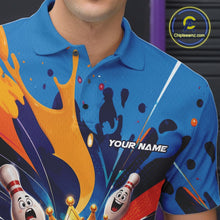 Load image into Gallery viewer, Close-up of the left chest on a bowling polo shirt featuring a crowned cartoon bowling ball holding a royal scepter with cheering animated bowling pins and colorful paint splashes.
