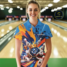 Load image into Gallery viewer, Front view of a female model wearing a bowling polo shirt featuring a crowned cartoon bowling ball holding a royal scepter with cheering animated pins and colorful paint splashes in a bowling lane.