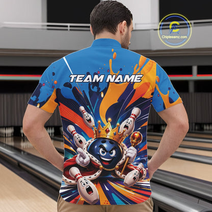 Front view of a male model wearing a bowling quarter zip shirt featuring a crowned cartoon bowling ball holding a royal scepter with cheering animated bowling pins and colorful paint splashes in a bowling lane.