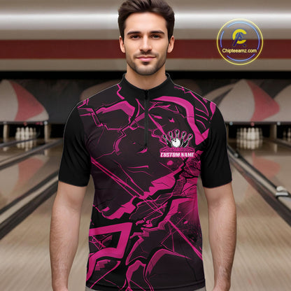 Male model wearing a black and pink quarter-zip in a bowling center featuring bold angular geometric artwork.