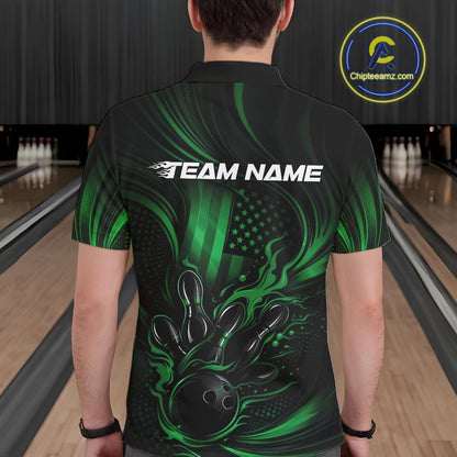 Back view of a male model in a bowling alley wearing a black and green polo featuring flaming bowling ball and American flag graphics.