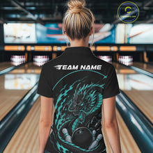 Load image into Gallery viewer, Back view of a female model in a bowling alley wearing a blue custom bowling polo shirt featuring an aggressive dragon with flames in a dynamic and energetic design.