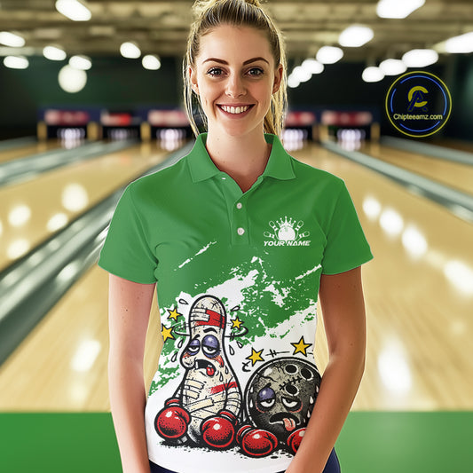 Female model in a bowling lane wearing a green and white polo shirt, cartoon boxing bowling ball and pin artwork with playful tone.