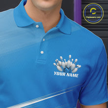 Load image into Gallery viewer, Close up left chest view of a blue bowling polo shirt with bowling ball and pins motif over a pink geometric pattern.