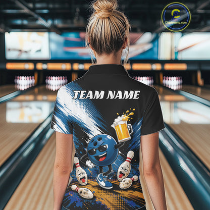 A woman viewed from behind wearing a black short-sleeve bowling-themed polo shirt with a colorful back graphic featuring a cartoon bowling ball, pins, and a beer mug, with the text 'TEAM NAME' across the upper back. The background shows a blurred bowling alley interior.