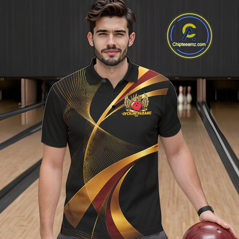 Man wearing a black bowling shirt with gold and red design in a bowling alley.