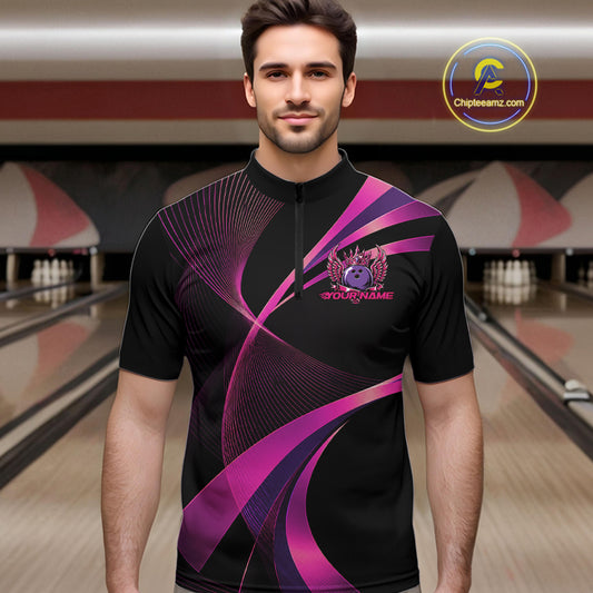 Man wearing a black and purple bowling shirt with a logo in a bowling alley.