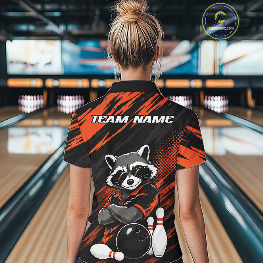 A woman viewed from behind wearing a bowling-themed short-sleeve polo shirt with a raccoon graphic and 'TEAM NAME' text, standing in a bowling alley.