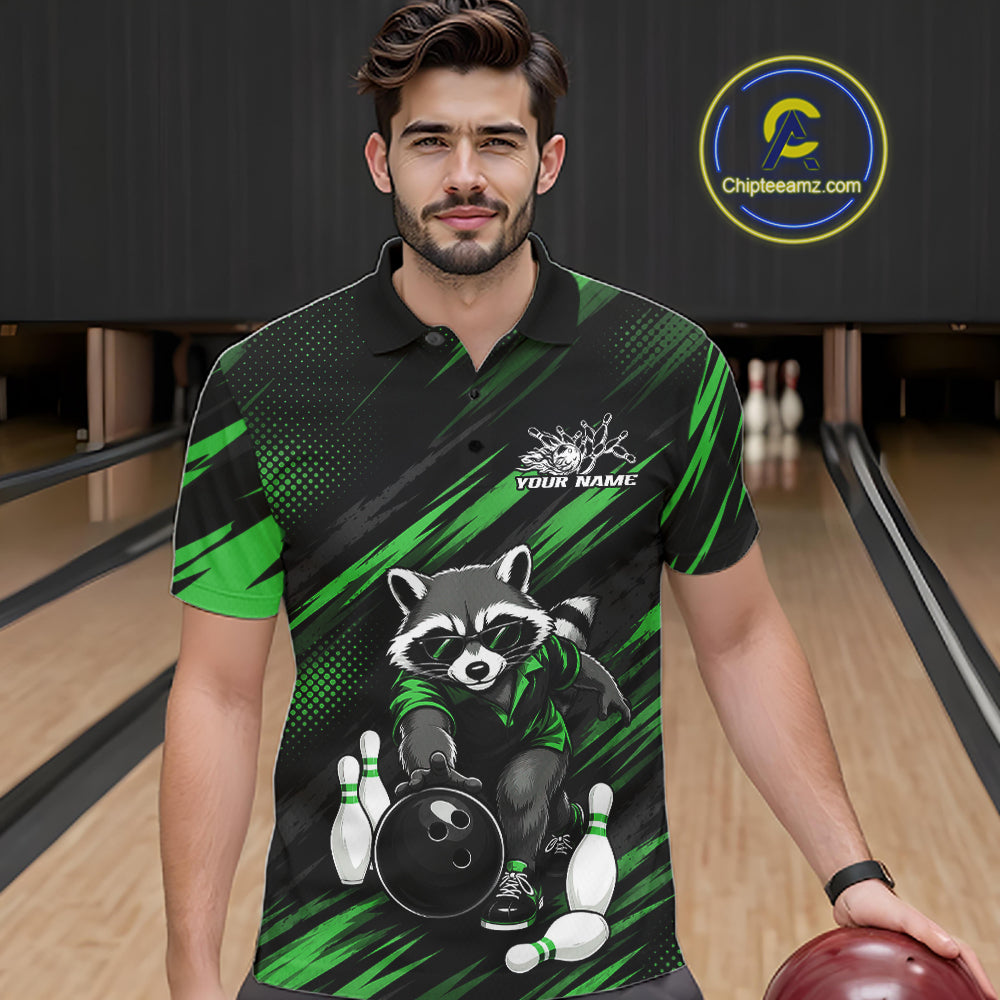 A man wearing a custom bowling-themed polo shirt with a raccoon graphic, standing in a bowling alley. The shirt features a black and green pattern with a cartoon raccoon holding a bowling ball and pins.