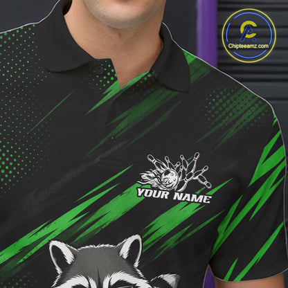 A close-up of a man wearing a black and green polo shirt with a raccoon graphic and a custom name patch on the chest. The shirt features a black collar and a pattern of green brushstrokes and halftone dots on a black background.