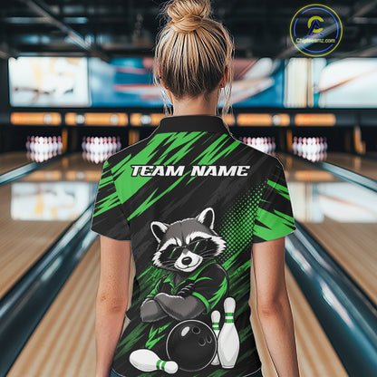 A woman viewed from behind wearing a custom bowling qurater zip shirt with a raccoon graphic and 'TEAM NAME' text, standing in a bowling alley.
