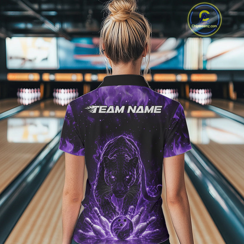 Back view of a female model in a bowling lane wearing a black quarter-zip shirt with glowing purple electric panther design and dynamic bowling strike graphics.