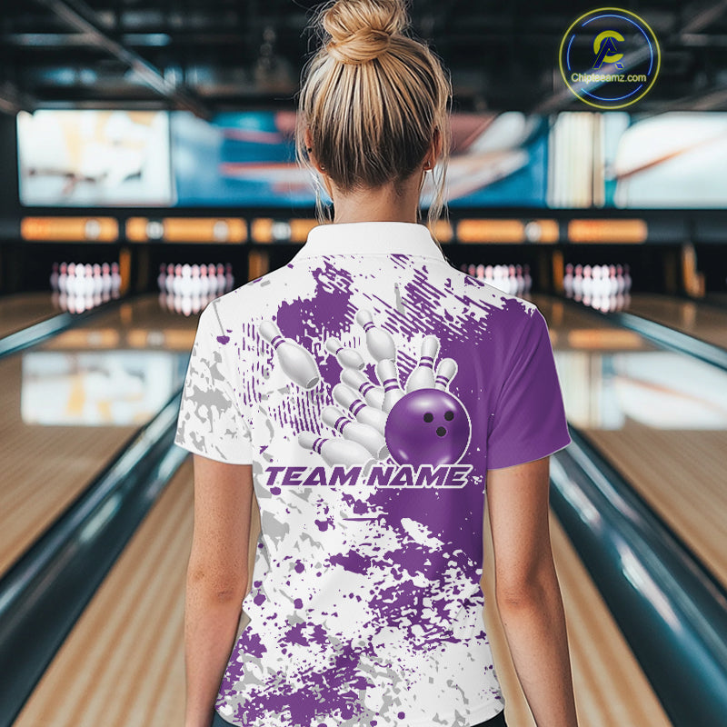 Back view of a female model in a bowling lane wearing a purple and white splatter bowling quarter-zip shirt with clean athletic bowling-inspired design.