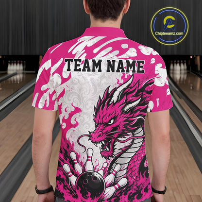 Person wearing a pink and white bowling shirt with a dragon design and 'TEAM NAME' text in a bowling alley.