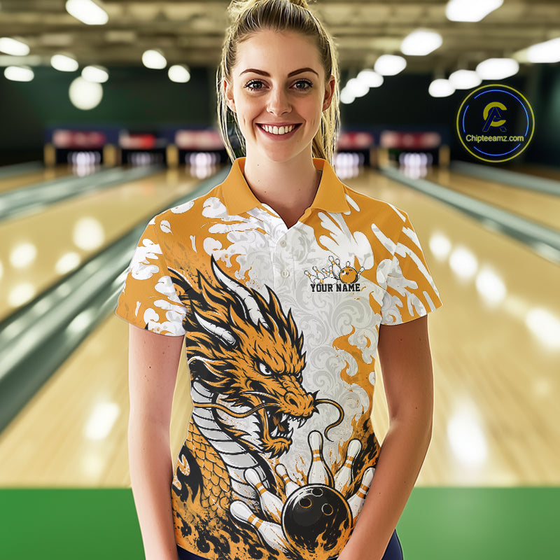Woman wearing a bowling shirt with a dragon design in a bowling alley.
