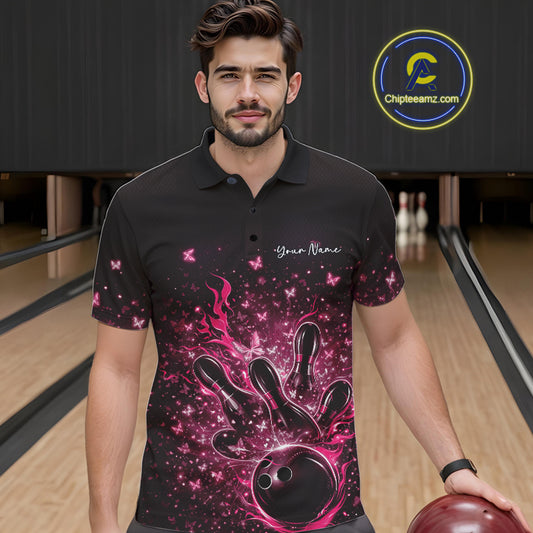 Male model wearing a black and pink bowling polo shirt at the lane with flaming ball and butterfly artwork.
