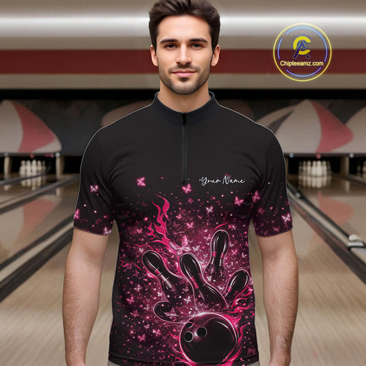 Male model wearing a black and pink bowling quarter-zip shirt at the lane with flaming bowling ball artwork.
