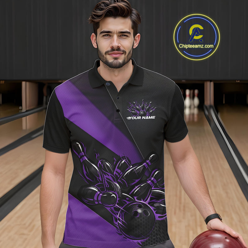 Male model seen from the front in a bowling lane wearing a black and purple polo shirt featuring a flame bowling ball striking pins in a dynamic sports action scene.