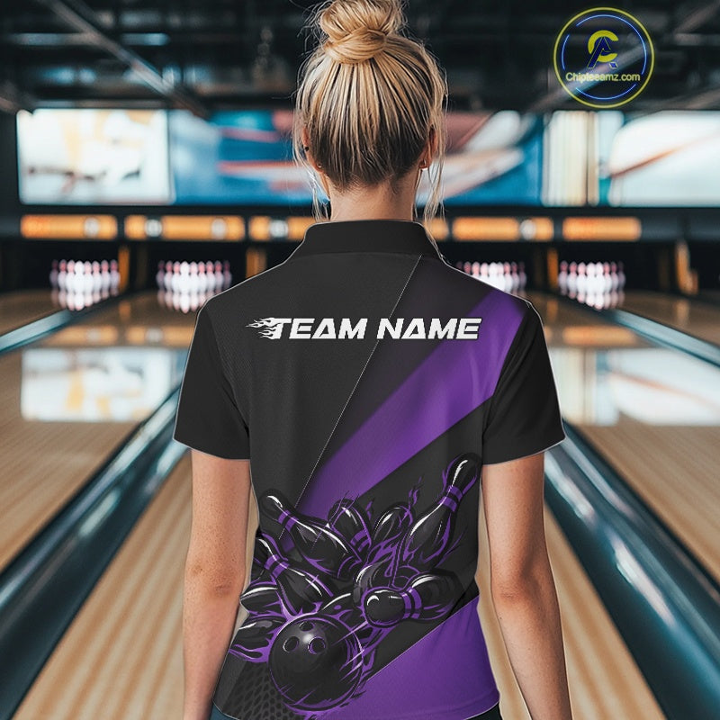 Female model back view in bowling center wearing black and purple polo shirt showcasing flame bowling ball striking pins in vivid motion artwork.