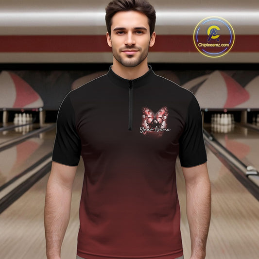 Male model at a bowling lane wearing a red bowling quarter-zip shirt with glowing butterfly artwork and a cosmic bowling theme.