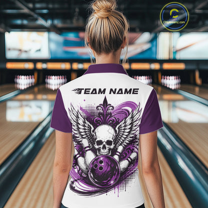 Back view of a woman in a bowling alley wearing a bowling shirt with polo collar, purple skull-themed bowling graphic with black wings, pins, bowling ball shirt with “Team Name” across the shoulders.