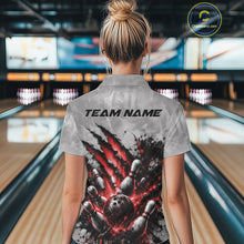 Load image into Gallery viewer, Back view of a female model wearing a gray bowling quarter zip shirt featuring a dramatic red bowling ball striking pins graphic with claw-mark artwork in a bowling lane.
