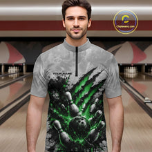 Load image into Gallery viewer, Front view of a male model wearing a gray bowling quarter zip shirt showcasing a dramatic green bowling ball and pins graphic with claw-mark artwork in a bowling lane.